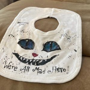 Alice in wonderland “precious one we’re all mad here!” Baby bib
